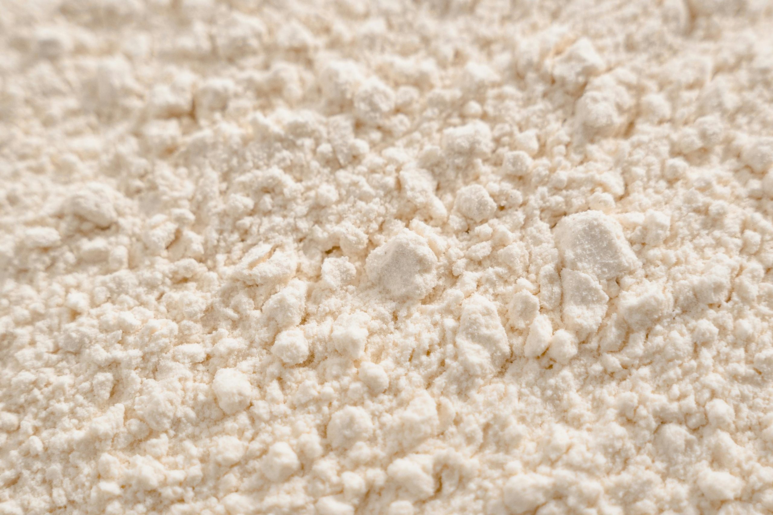Detailed close-up of a white powder texture, resembling flour or sugar.